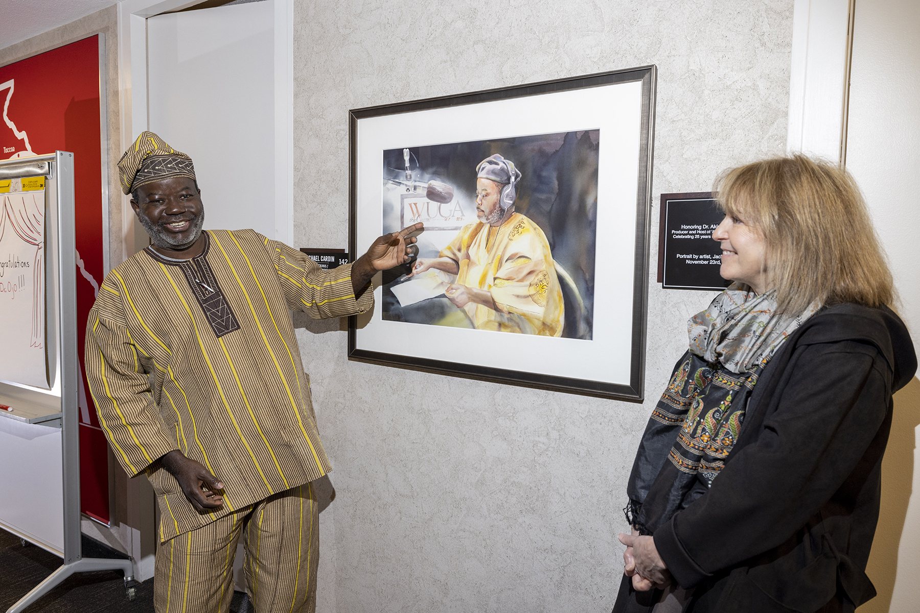 photo of two people and painting