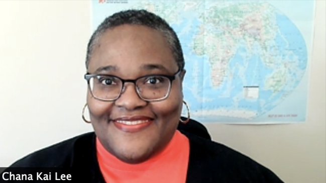 photo of woman, with wall map in background