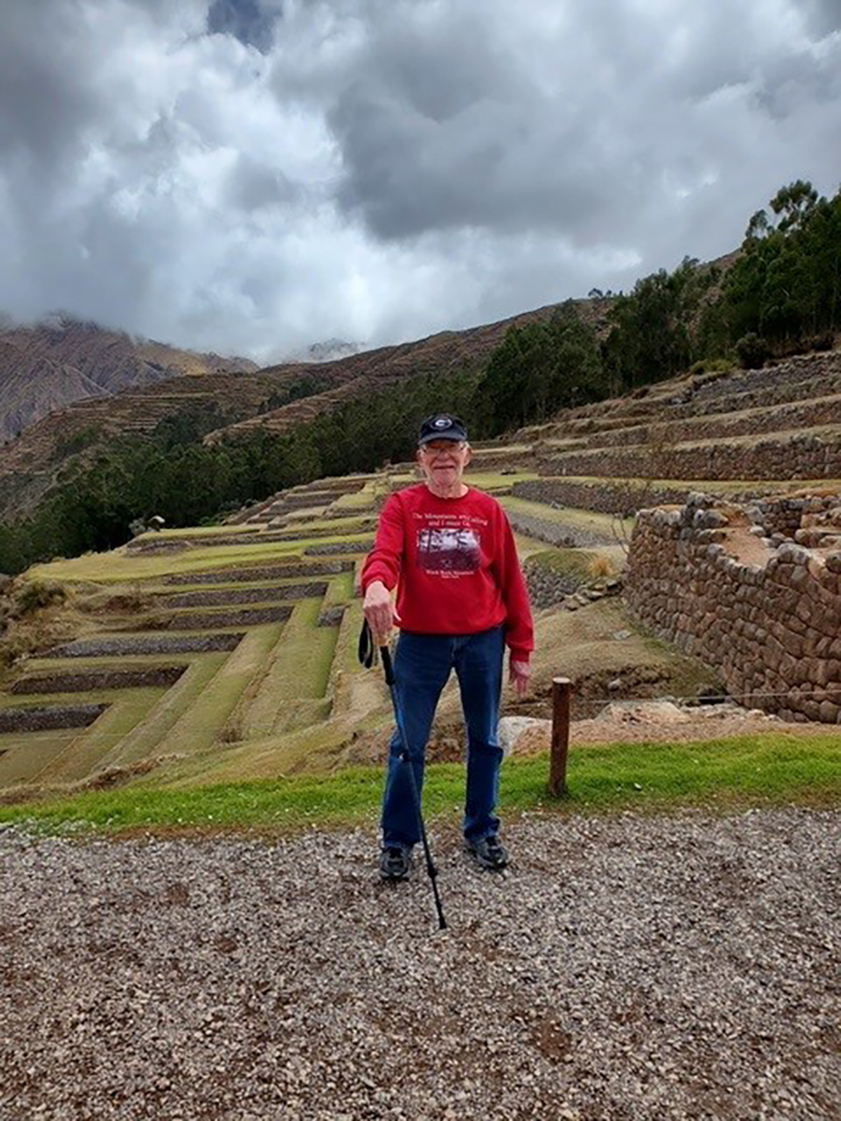 photo of man, ancient terraces in background, day