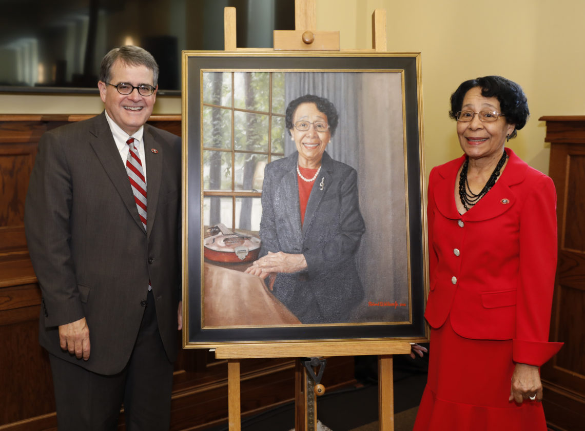 photo of two people with a painted portrait