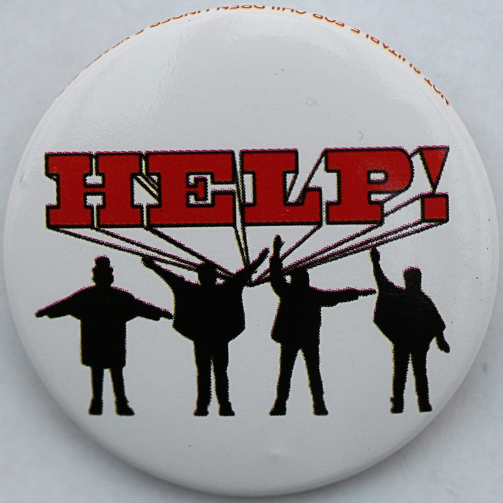 photo of button with the HELP! and four figures