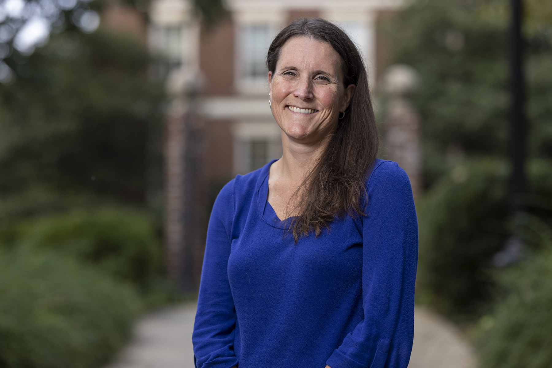 photo of woman outdoors, blurred gates in background