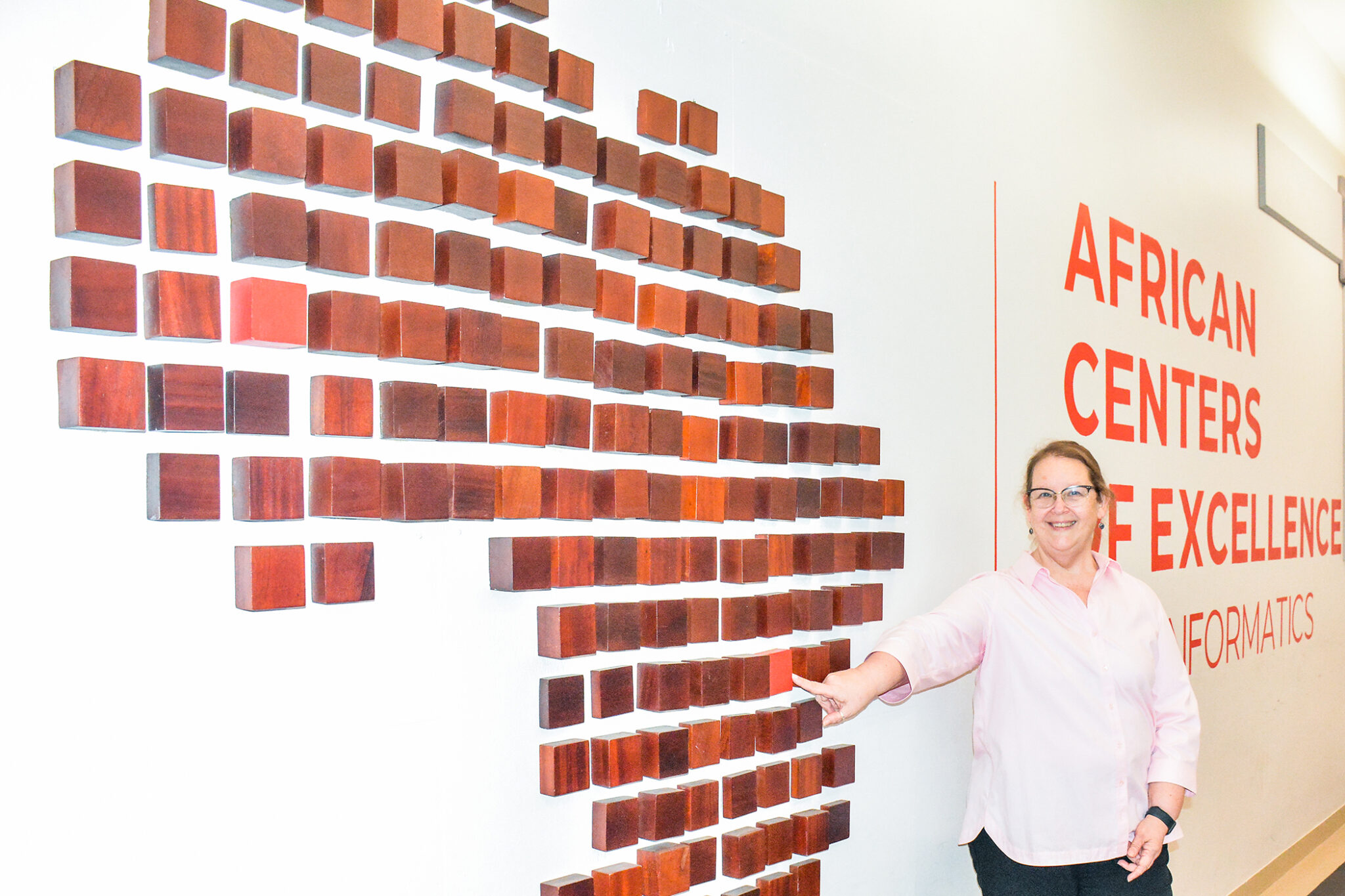 photo of woman standing next to outline of Africa