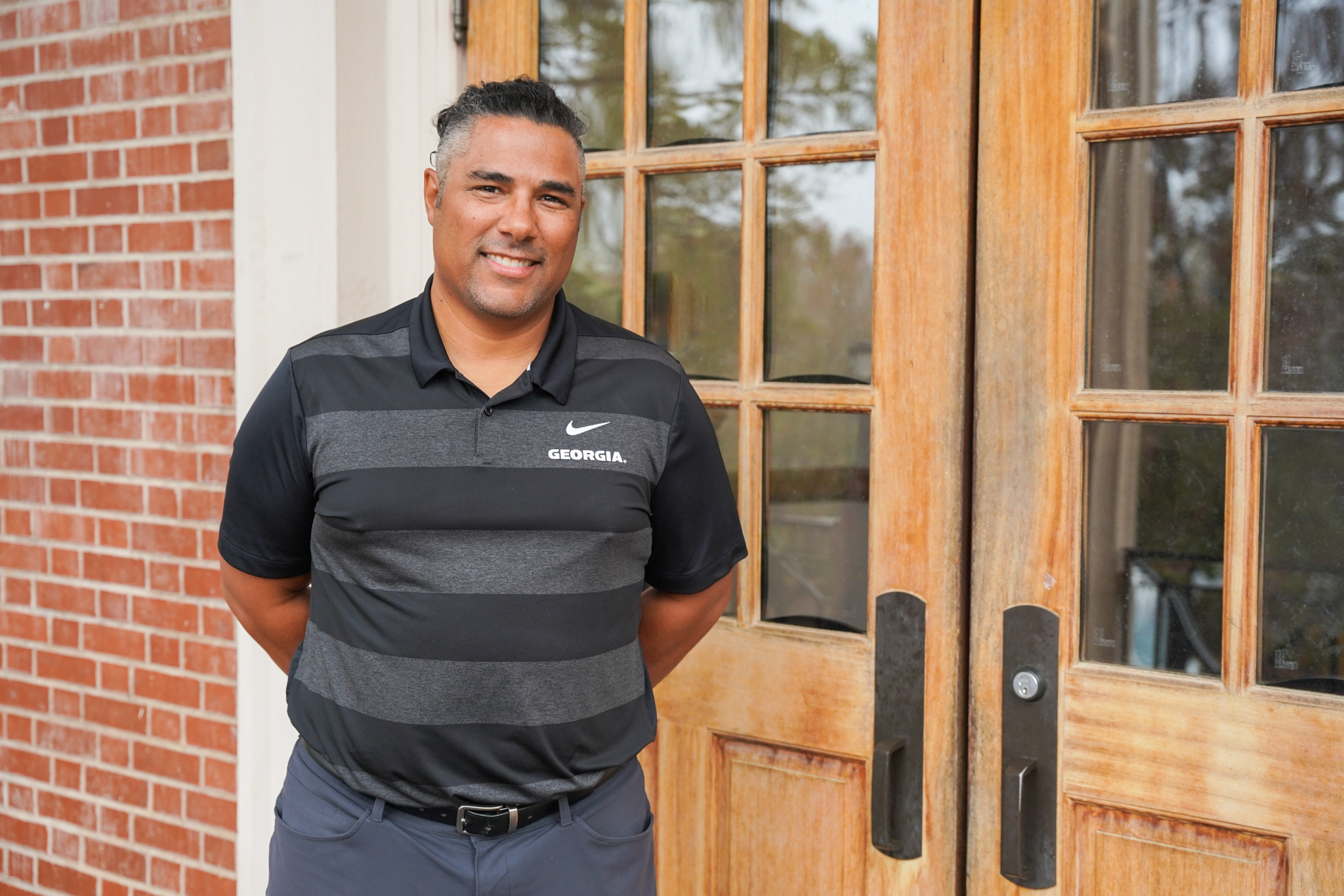 photo of man in front of double doors