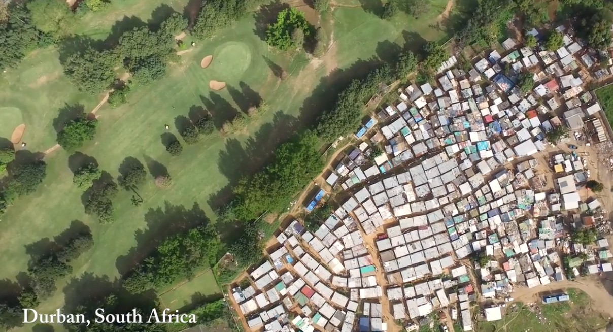 aerial photo of golf course contiguous to dense housing