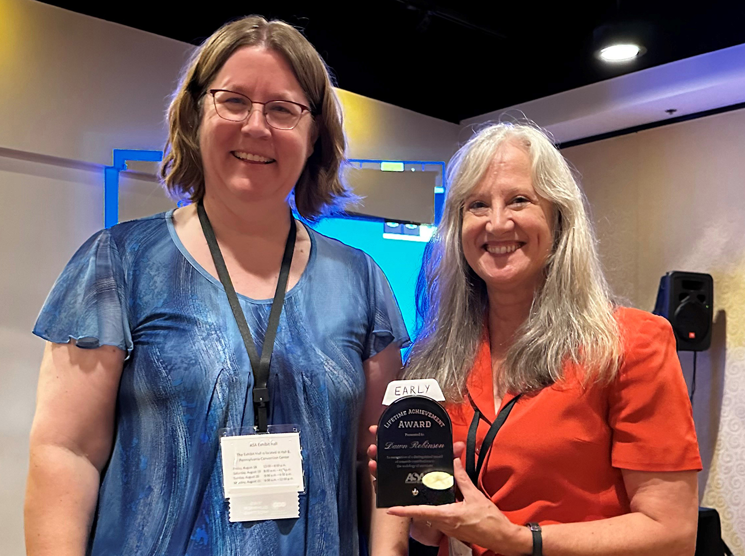 photo with two people, one with award