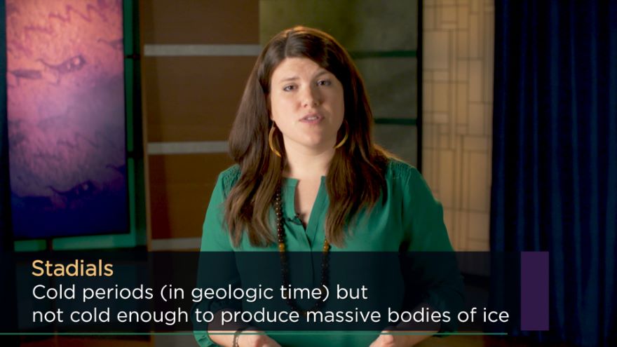 video still photo of woman in TV studio, with lower third graphic text