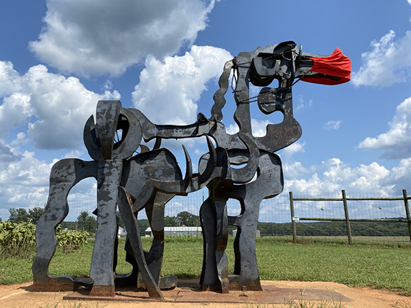 photo of iron sculpture, blue sky