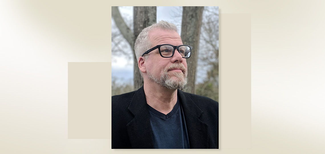 headshot of man, with color graphic block