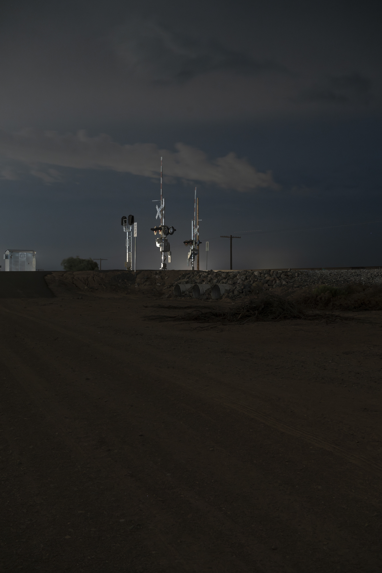 photo of a railroad crossing at night