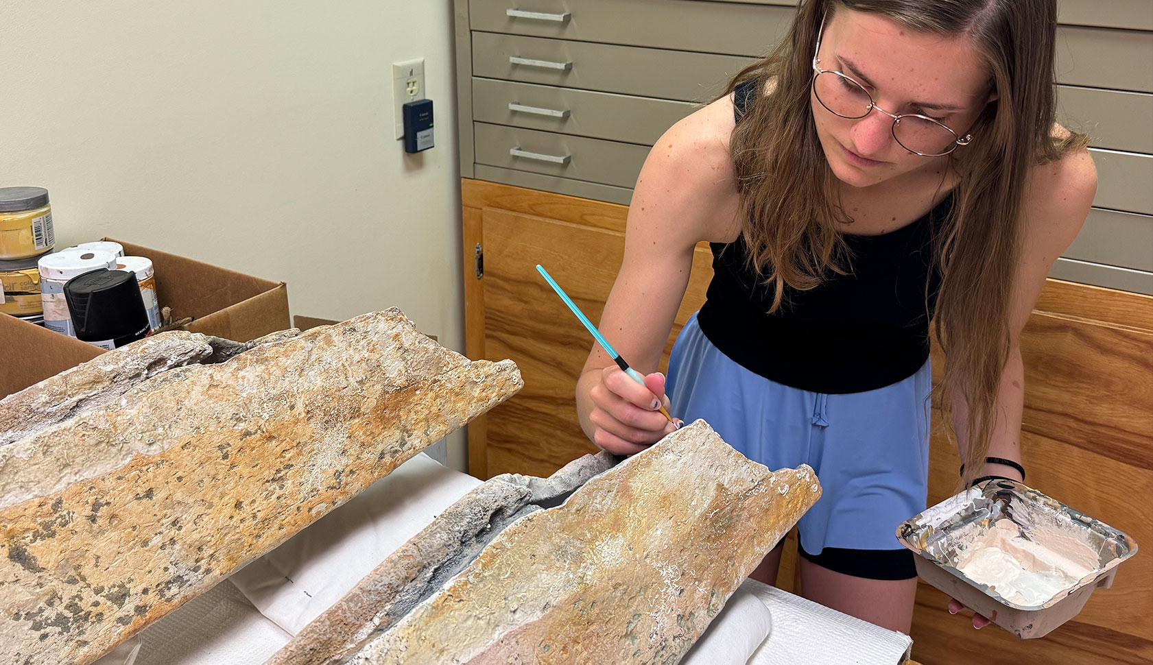 Grace Maavere paints a whale mandible