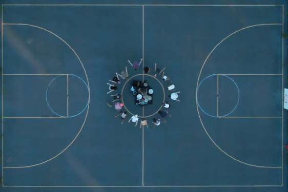 photo of basketball court with people at the center, from above